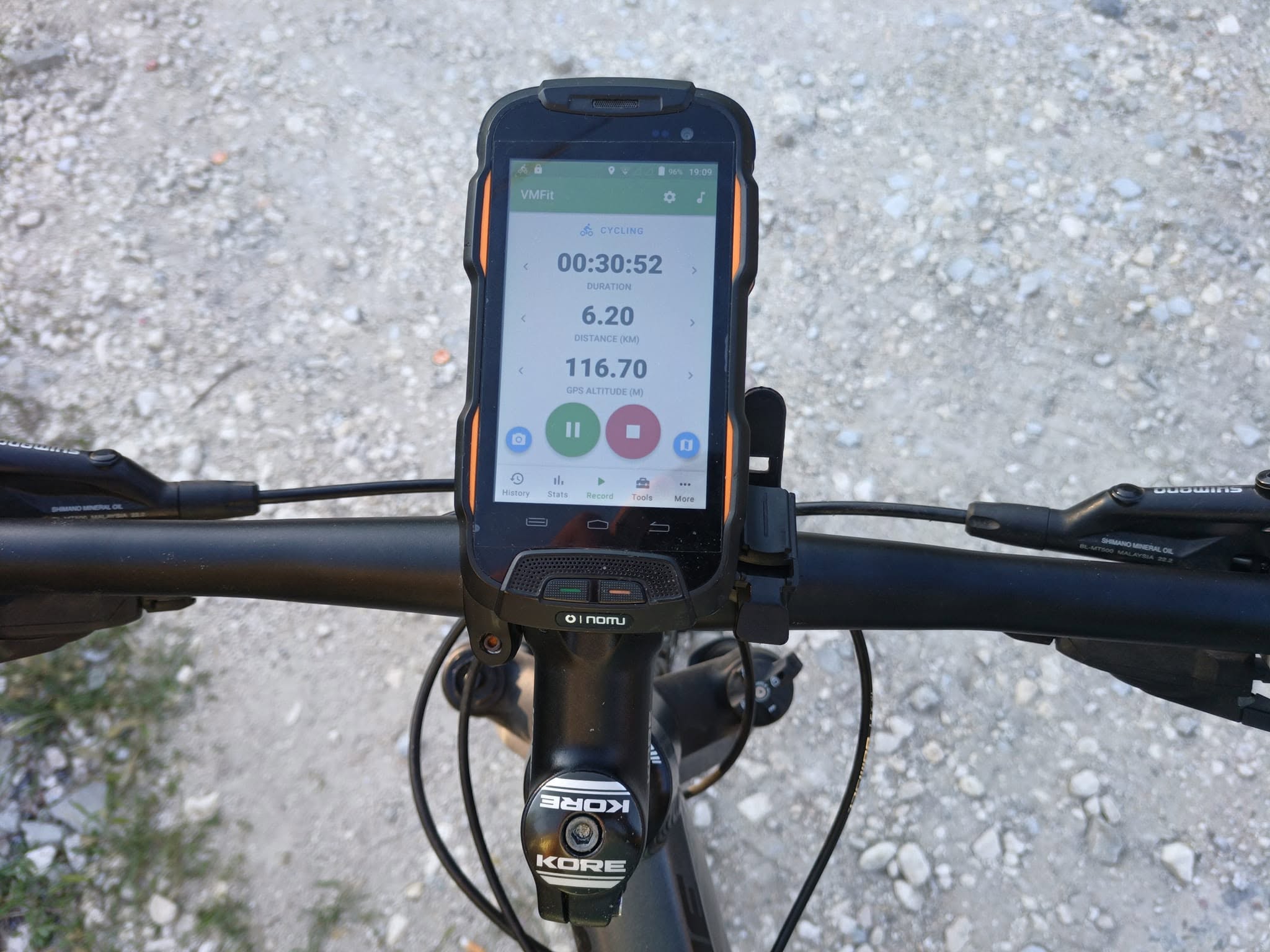 Phone running VMFit mounted on bicycle handlebars during an outdoor test ride